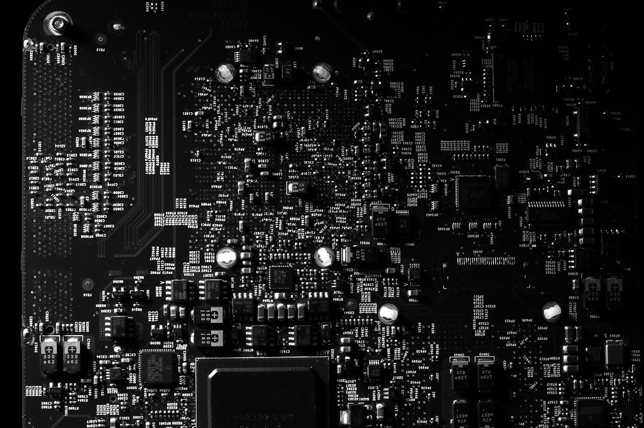 Detailed black and white photo of a circuit board showing intricate components, perfect for tech projects.
